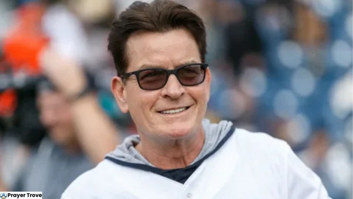 Charlie Sheen wearing sunglasses and a white hoodie